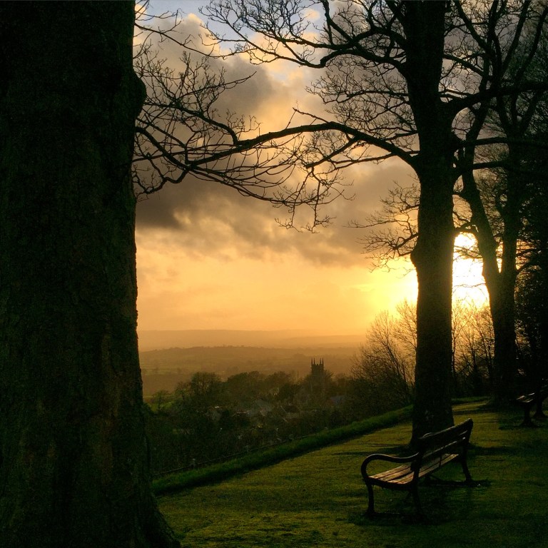 Park Walk, a pedestrianised promenade in Shaftesbury, Dorset, with a view of St James Church and the rolling countryside behind