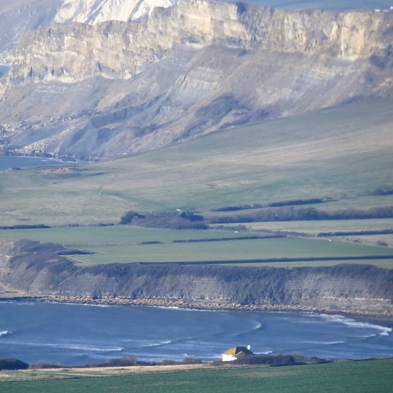 The White House on the edge of Kimmeridge Bay with Gad Cliff behind
