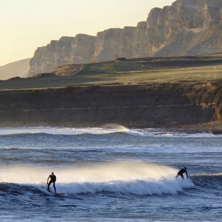 Surfers at Kimmeridge Bay