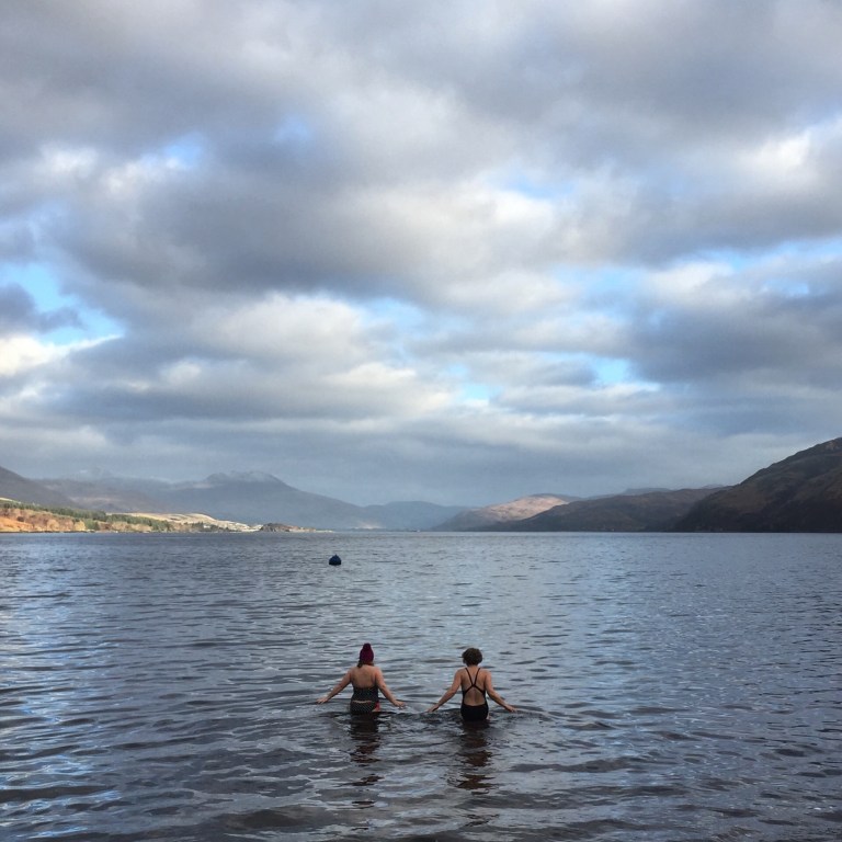 Two women swimming in Loch Carron in winter